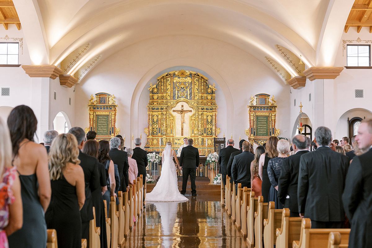 Ceremony details framed by soft white florals at a Rancho Bernardo Inn wedding in San Diego, planned by Bliss Events.