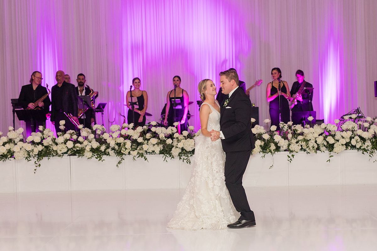 Annie and Zach in the candlelit ballroom at their Rancho Bernardo Inn reception in San Diego, planned by Bliss Events.