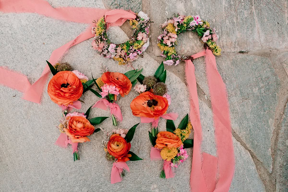 Garden wedding ceremony arch with lush greenery and soft pink florals at a private residence.