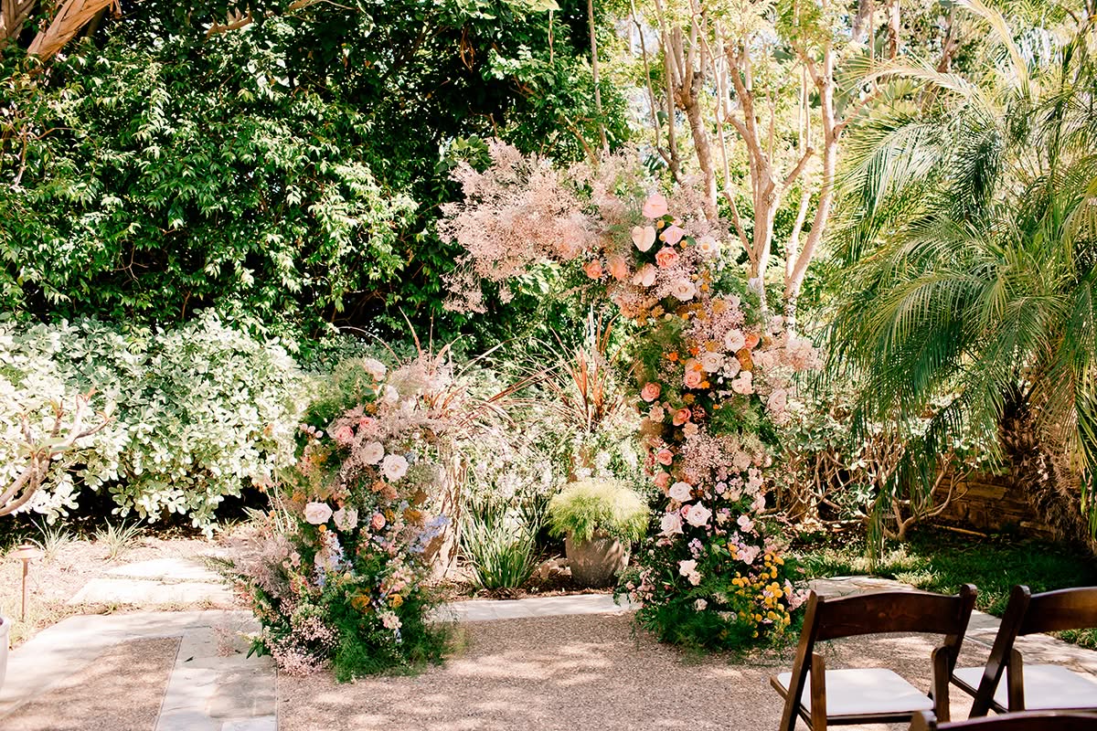 Bright floral wreaths and ribbon details arranged for a colorful garden wedding.