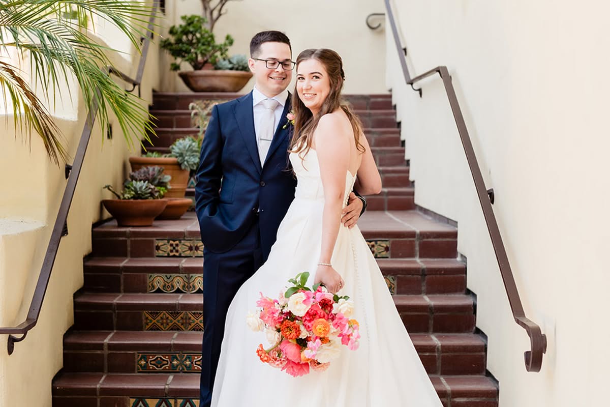 Katie and Jake pose together on a tiled staircase at Estancia La Jolla Hotel & Spa.